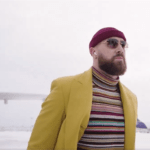 Travis Kelce’s Travel Suit and Striped Shirt Looks Suspiciously Similar to One of Taylor Swift’s ‘Anti-Hero’ Looks